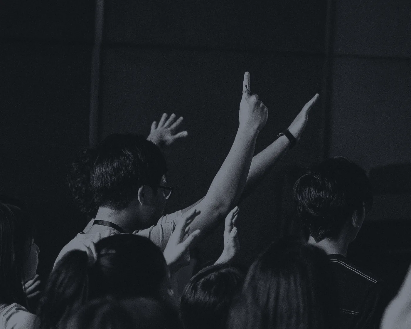 Students with hands raised in worship